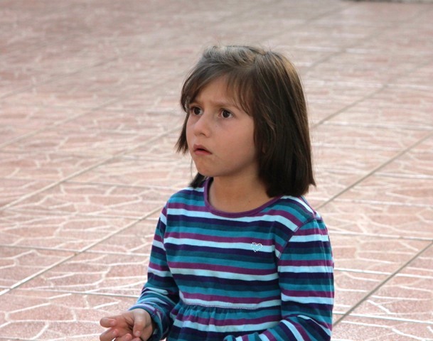 Young girl looks wisfully into an uncertain future.